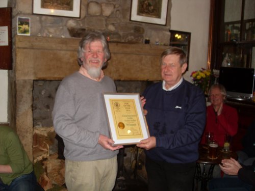 Chairman Michael Dillon presents the certificate to proprieter Joe Moore