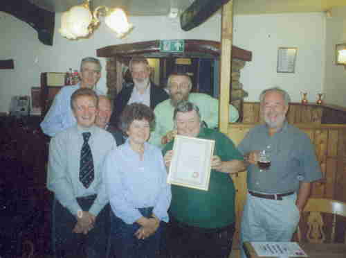 CAMRA members gather round as chairman Jenny Greenhalgh presents Colin Elsdon with an award on his retirement as landlord of the Marton Arms (Thornton-in-Lonsdale)